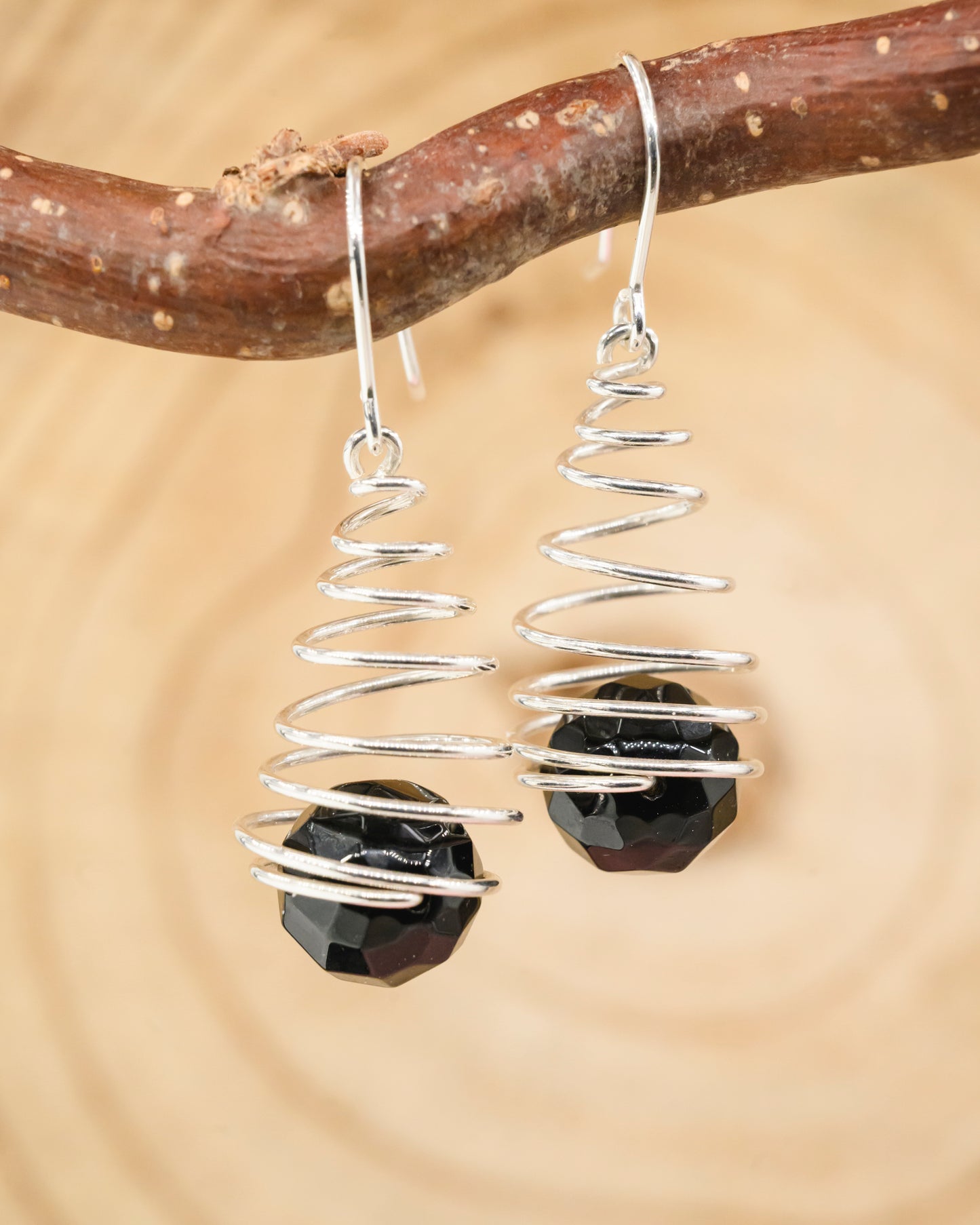 Spiral earrings with faceted onyx beads