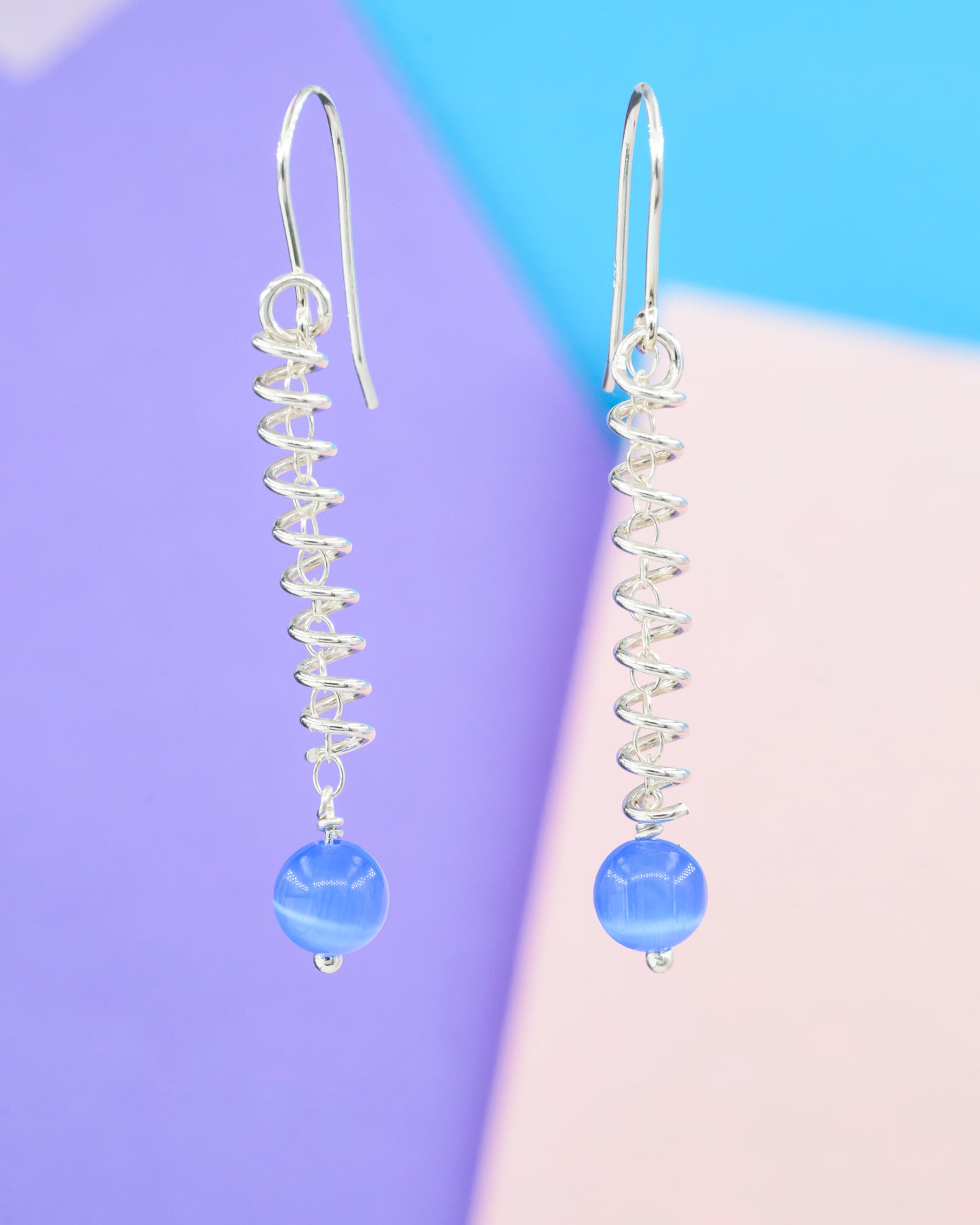 Narrow spiral earrings with blue cat's eye