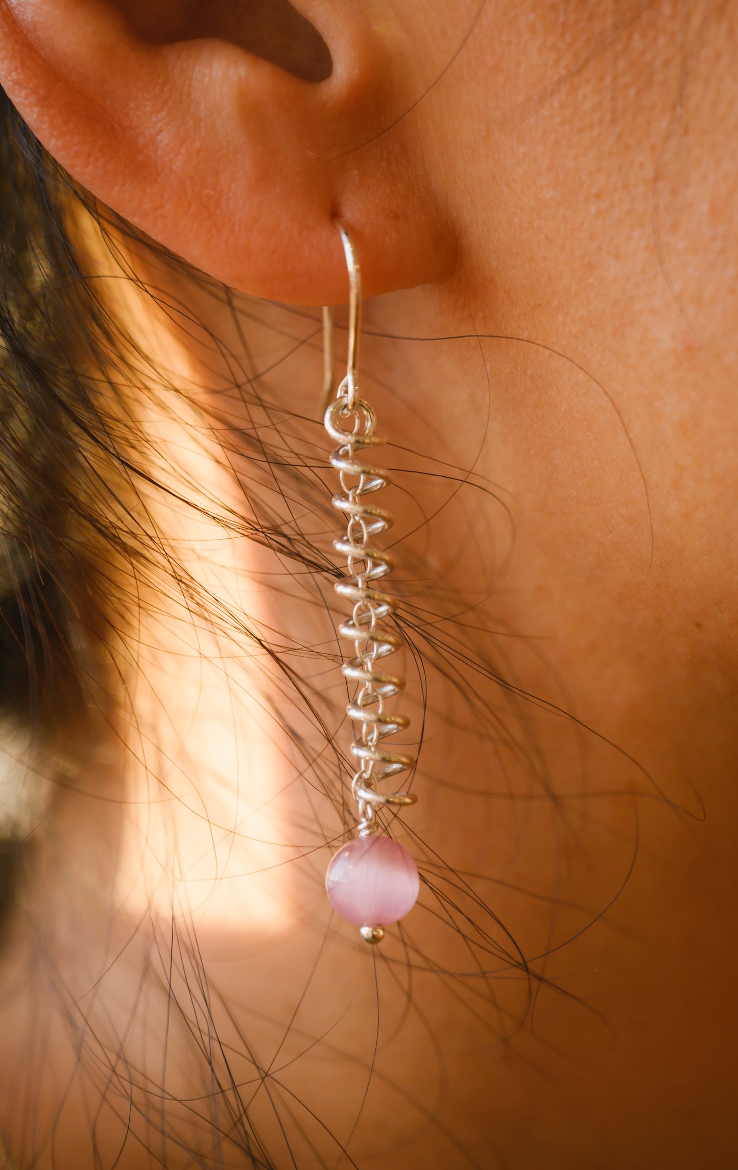 Narrow spiral earrings with pink cat's eye