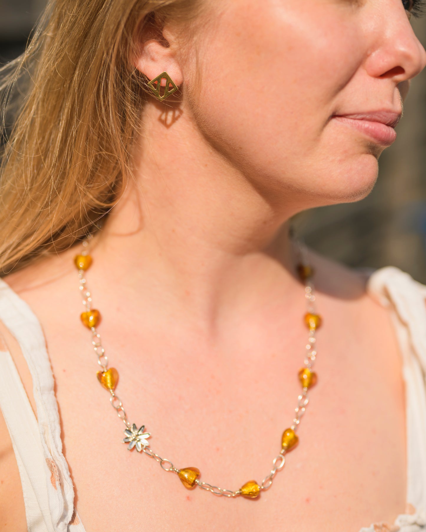 Necklace with silver flower and golden hearts
