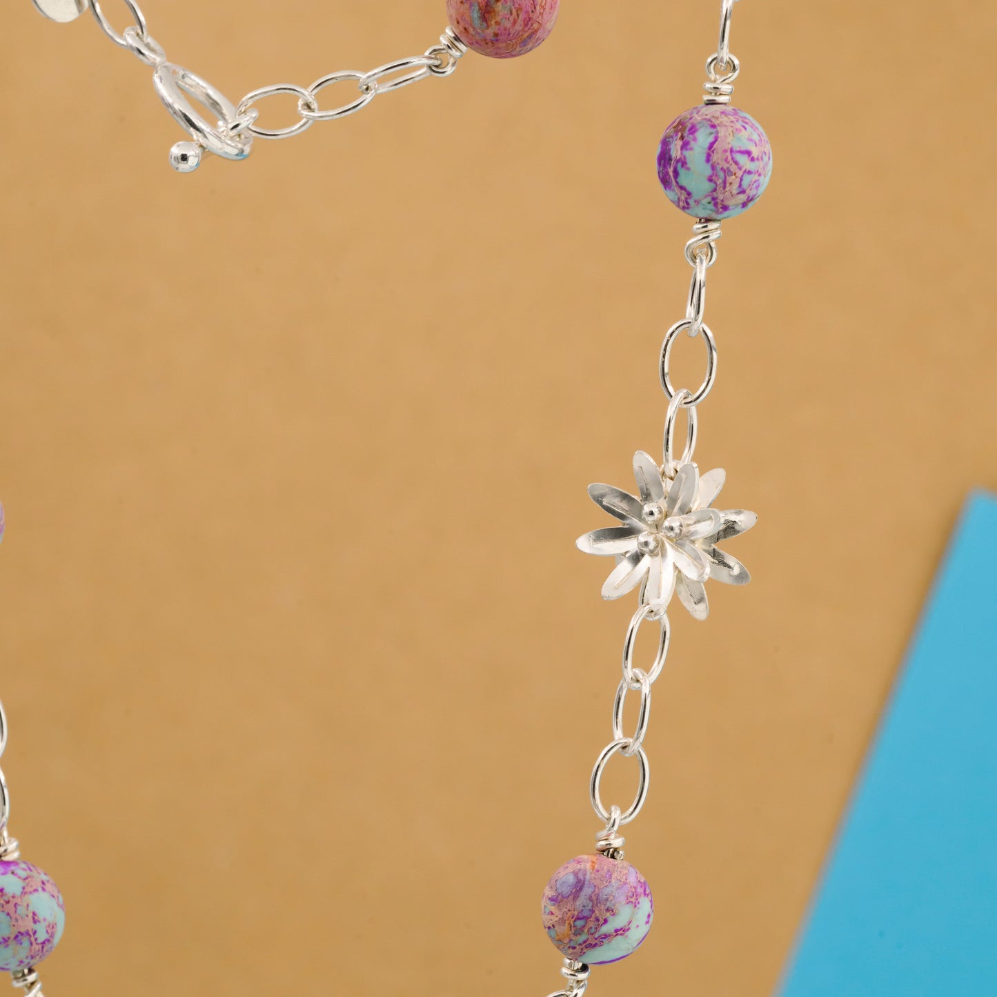 Necklace with aquamarine stone and a silver flower