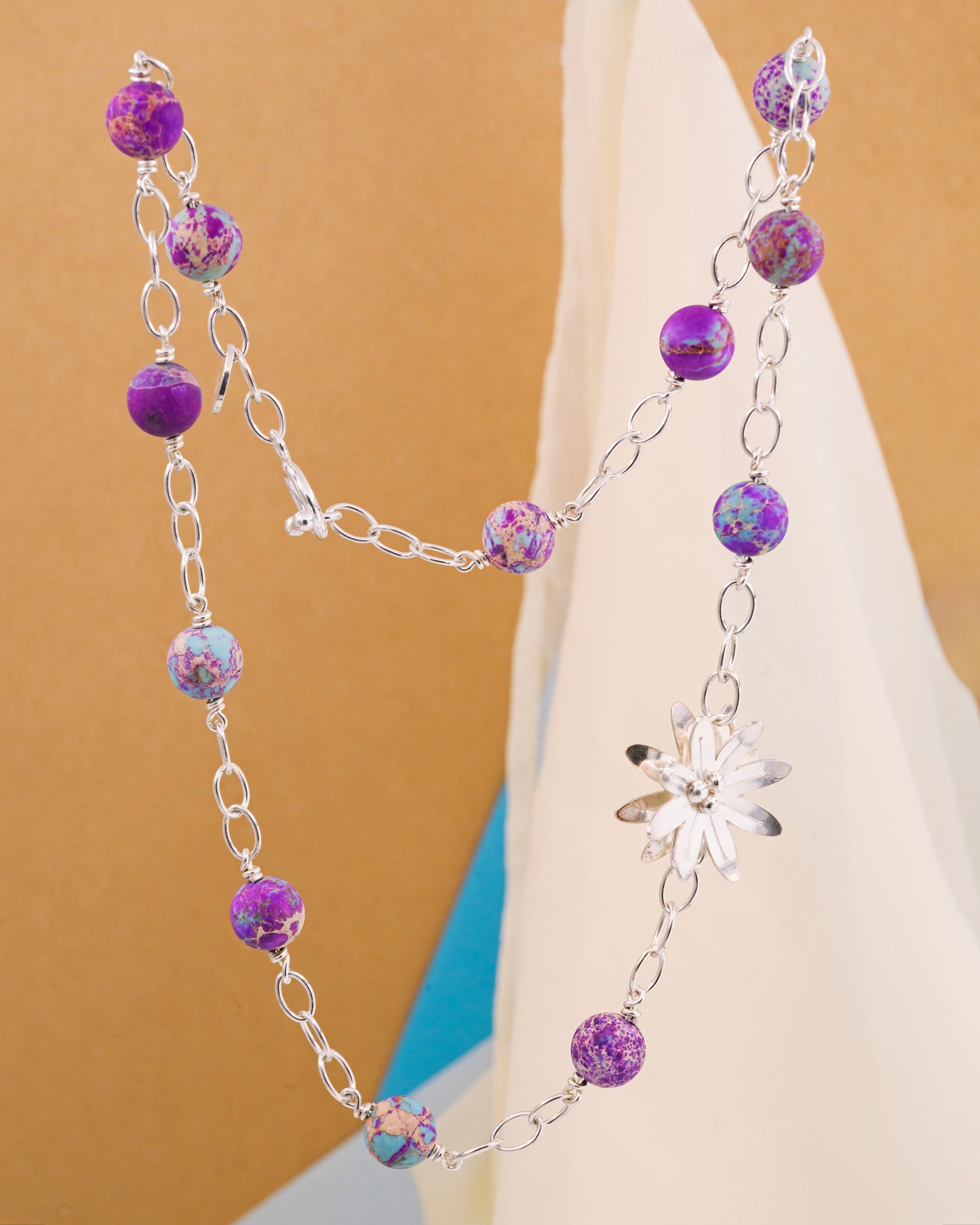 Necklace with aquamarine stone and a silver flower