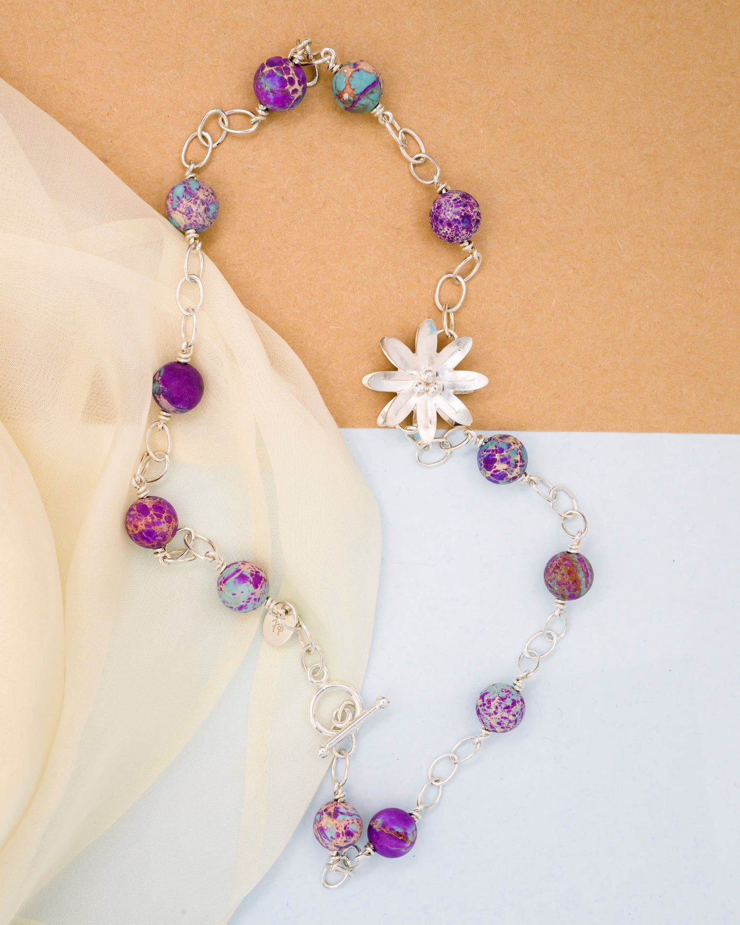 Necklace with aquamarine stone and a silver flower