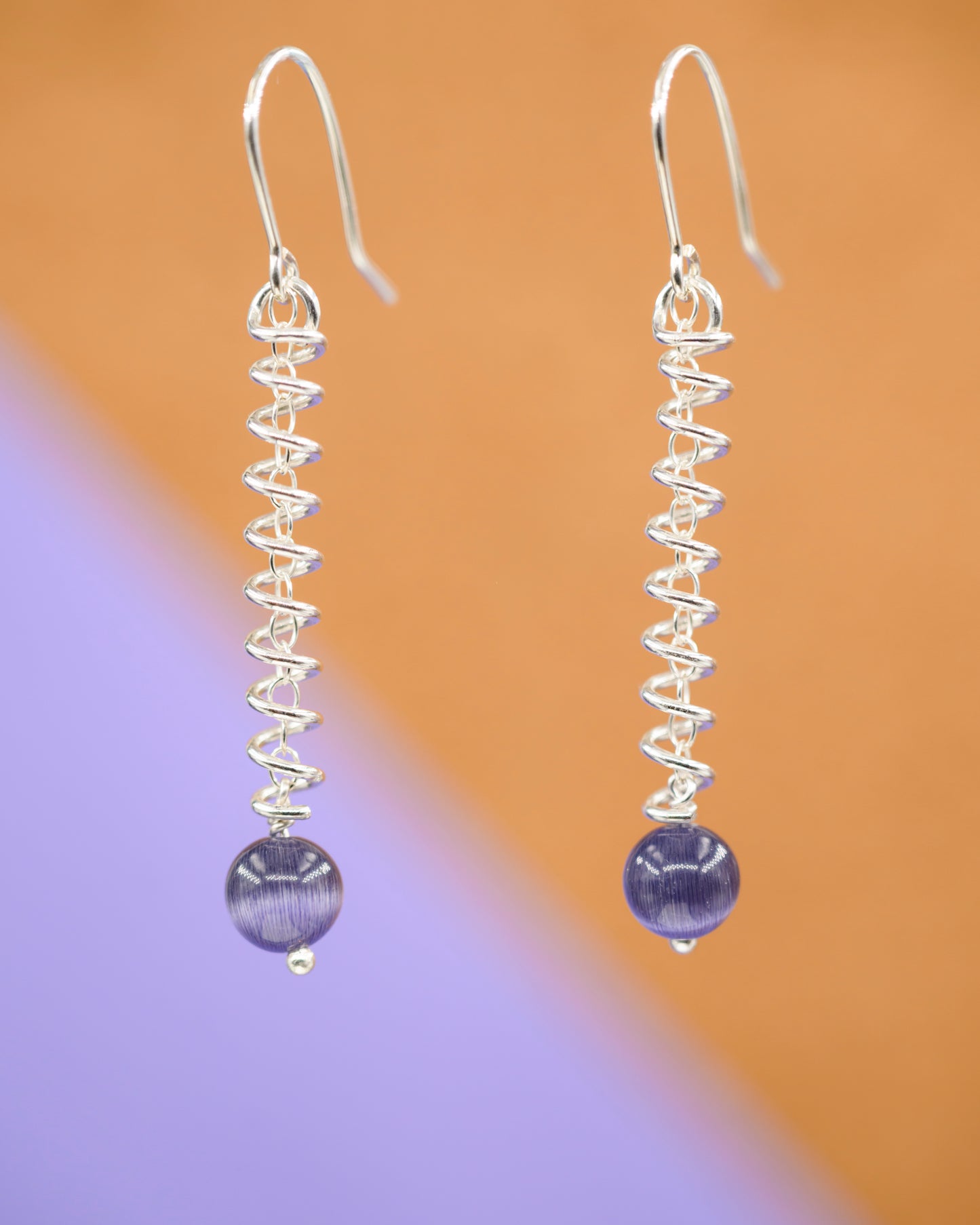 Narrow spiral earrings with purple cat's eye