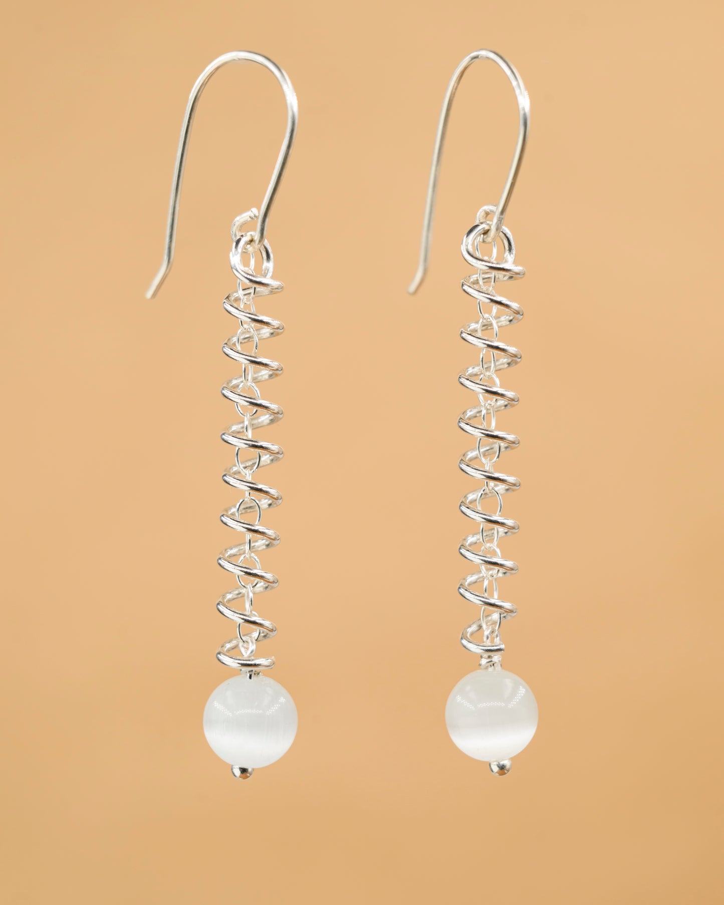 Narrow spiral earrings with white cat's eye