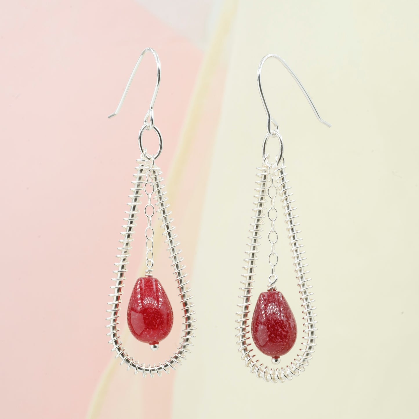 Drop-shaped earrings with red glass beads